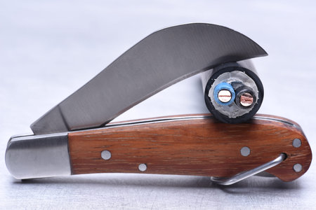 Utility knife tool with cable closeup isolated on white backgroundの写真素材