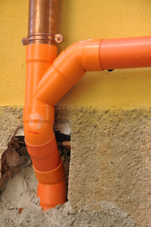 Installation of gutters in the old townの写真素材