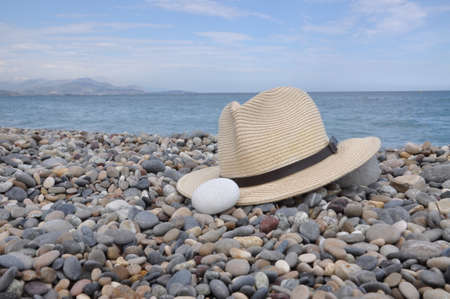 Hat on stone beach on the seashoreの写真素材