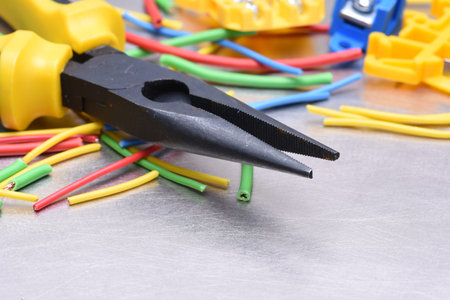 Tools for electrician and cables on gray metal surfaceの写真素材