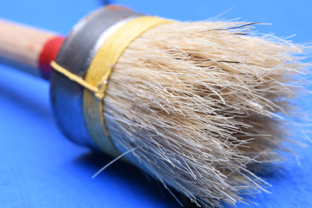 Paintbrush on wood background closeup