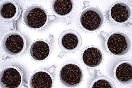 Group of coffee cup with roasted beans top view on metallic gray background