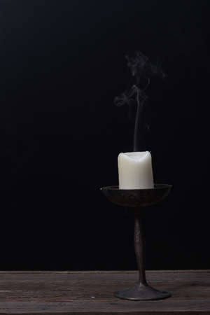 Candlestick and Candle with Smokeの写真素材