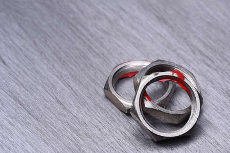 Steel Nuts on Metal Background, Copy Spaceの写真素材