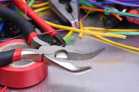 Set of electrical tools and components on metal backgroundの写真素材