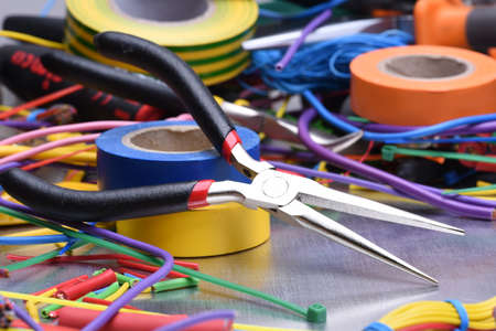 Set of electrical tools and components on metal backgroundの写真素材