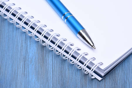 Notebook with blue pen closeupの写真素材