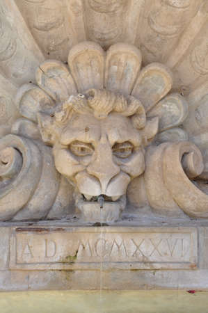 Tuscan fountain with stone lion headの写真素材