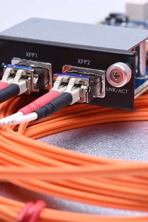 Network optical fiber cables connected to gigabit interface converterの写真素材