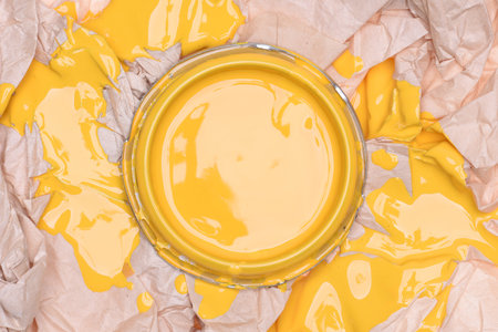 Canvas with yellow paint on crumpled paper, top viewの写真素材