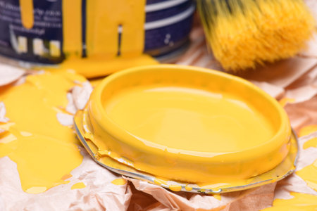 Paintbrush and can with yellow paint, closeupの写真素材
