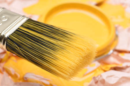 Paintbrush and can with yellow paint, closeupの写真素材