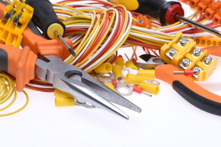 Set of electrical tools and cables on white background