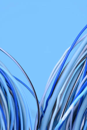 Electrical wire on blue background with place for textの写真素材