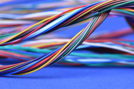 Colorful electrical cables on blue background