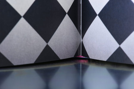 Opened book on metal table with reflection