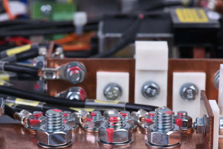 Copper bus connector for industrial power supply devices with bold connection close-up, detail of connections with selective focus horizontalの写真素材
