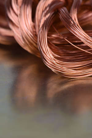 Closeup of Copper Wire on Metal Surface with Reflectionの写真素材