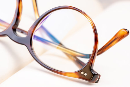Macro of reading glasses on opened book