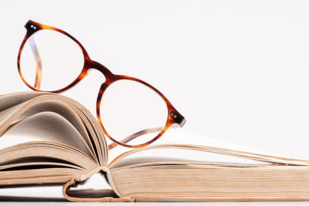 Eyeglasses on open bookの写真素材