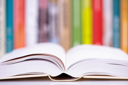 Close-up open book with library bookshelf toned backgroundの写真素材