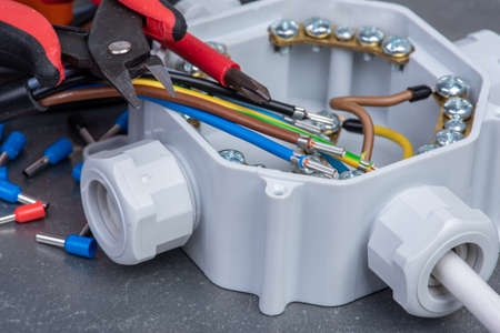 Tools and stripped cables used in electrical home installationの写真素材