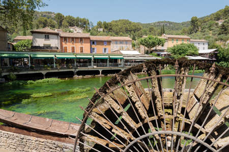 Famous place of Provence France, Fontaine de Vaucluse village on Sorgue river, water wheel with and clean green waterの写真素材
