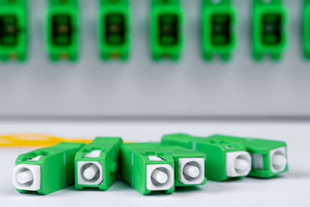 Fiber optic connectors closeup and distribution frame in backgroundの写真素材