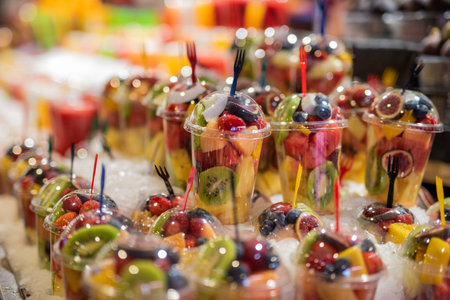 Sliced fresh fruit in plastic cup on street market