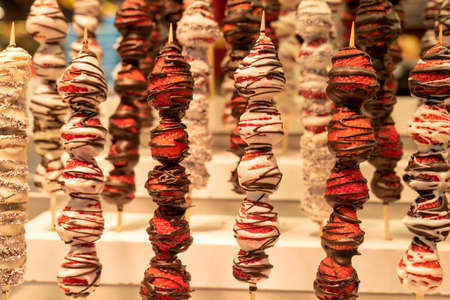 Chocolate covered strawberries, sweet snacks at street marketの写真素材