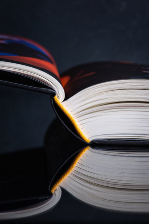 Macro of opened book with reflection on tableの写真素材