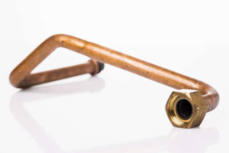 Plumbing part isolated on white workshop table, old item after service and repairの写真素材