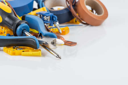 Electrical accessories and hand tools on white workshop tableの写真素材