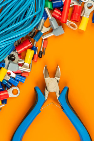 Tool and accessories used in electrical installation on workshop table directly above