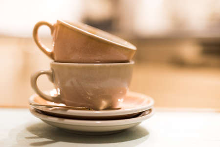 Stack of Empty Coffee Cup After Drink Cappuccino with Soft Blurred Backgroundの写真素材