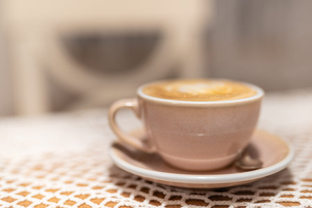 Cup of cappuccino on table with soft blurred backgroundの写真素材