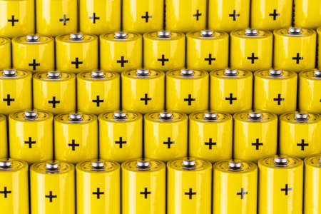 Group of alkaline battery aaa size in row with plus sign of positive polesの写真素材