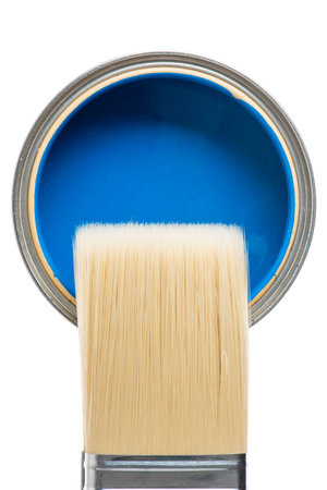 Paintbrush and open can of paint close-up directly above on white background