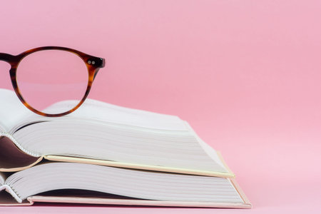 Opened book with reading glasses