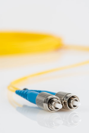 Fiber optic single mode patch cord connector type FC with blurred background