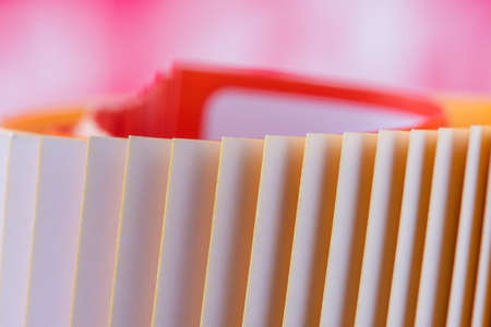 Macro of edge colorful rolled up magazine paper with blurred backgroundの写真素材