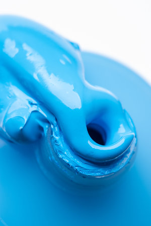 Macro of a blue acrylic paint oozing out from a paint tubeの写真素材