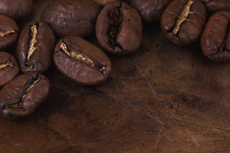 Roasted coffee beans and ground on brown roaster backgroundの写真素材