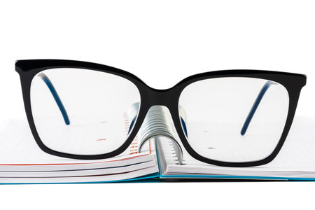 Reading glasses on opened ring binder notebook
