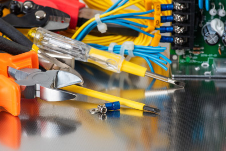 Set of electrician tools and equipment on a metal background, closeupの写真素材