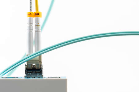 Closeup of internet network switch with optical module and patch cord cable isolated on white backgroundの写真素材