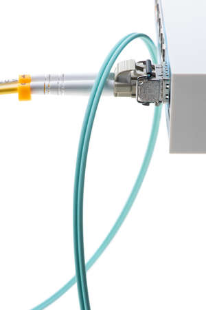 Closeup of internet network switch with optical module and patch cord cable isolated on white backgroundの写真素材