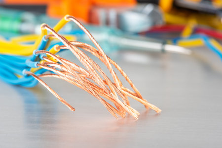 Copper cable wire and set of electrician tools in blurred backgroundの写真素材
