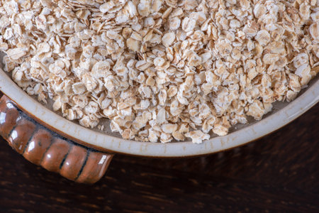 Oat flakes in ceramic bowl macro view