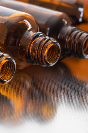 Set of opened small brown glass bottles for medicine, fragrance, essence oil and potionの写真素材